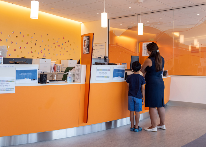 Parent and child patient at RSZ TNC check-in desk